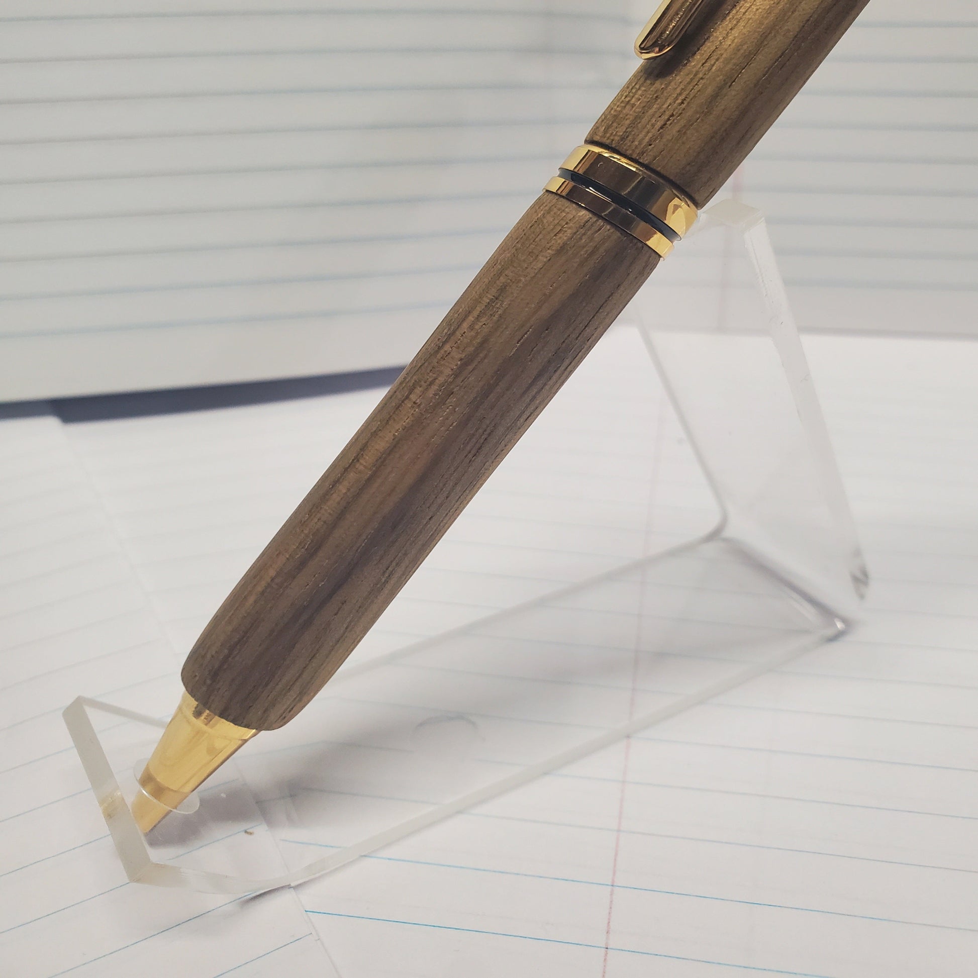 Closeup of lower half of Black Limba writing pen showing wood grain