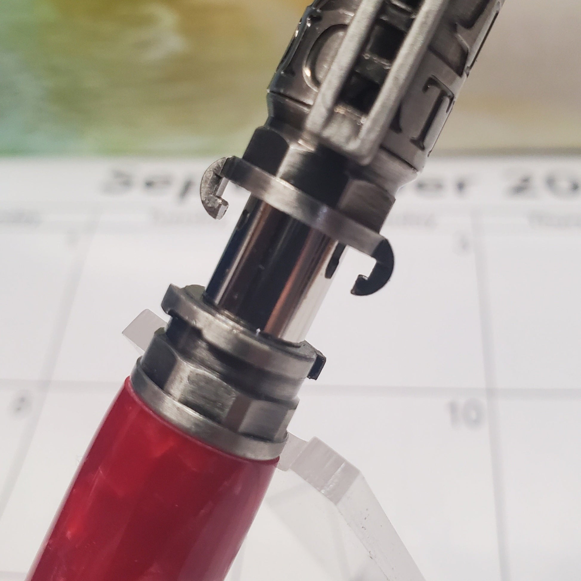 Close-up of a red and silver firehose connection on the firefighter pen