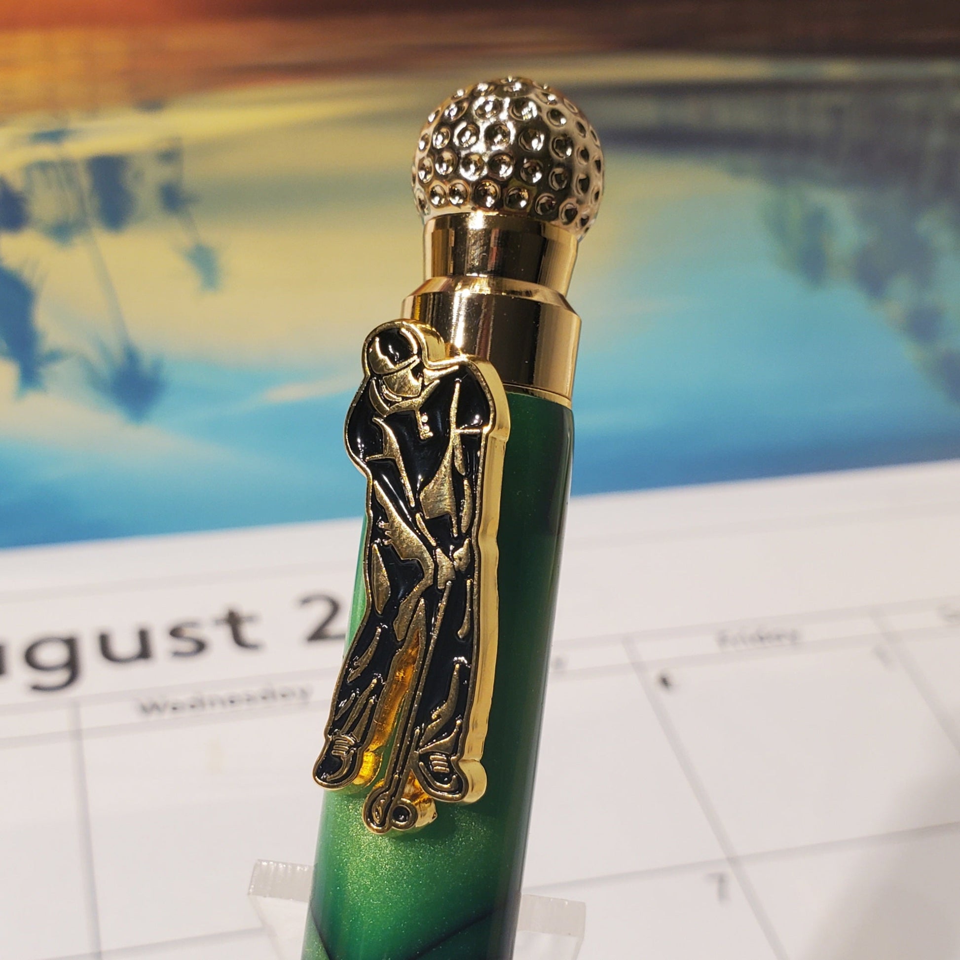 Close-up of the top of the Golf pen featuring a clip designed to look like a golfer and a cap that resembles a golf ball.