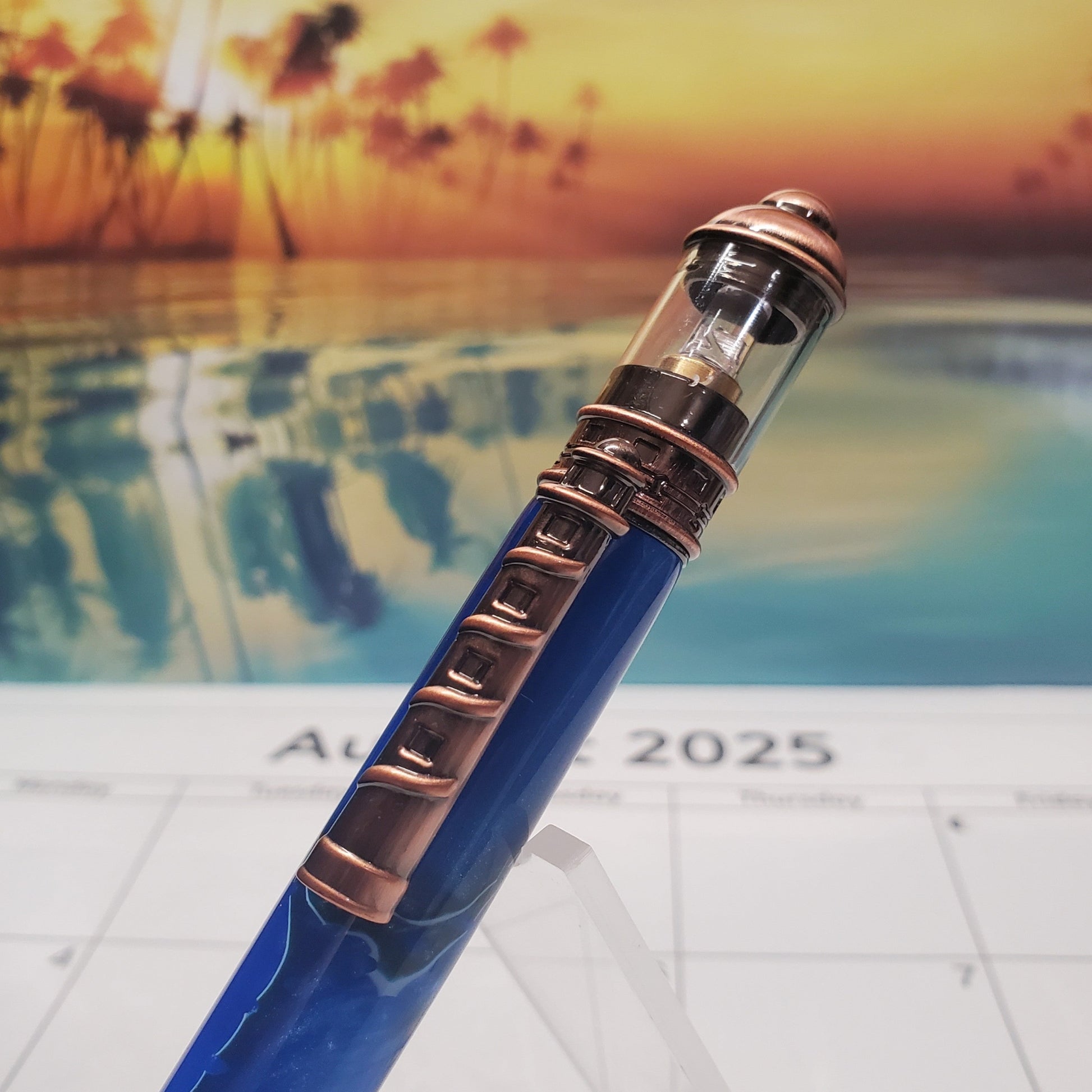 Close-up on the top of the lighthouse Pen featuring copper clip that resembles a lighthouse and a light