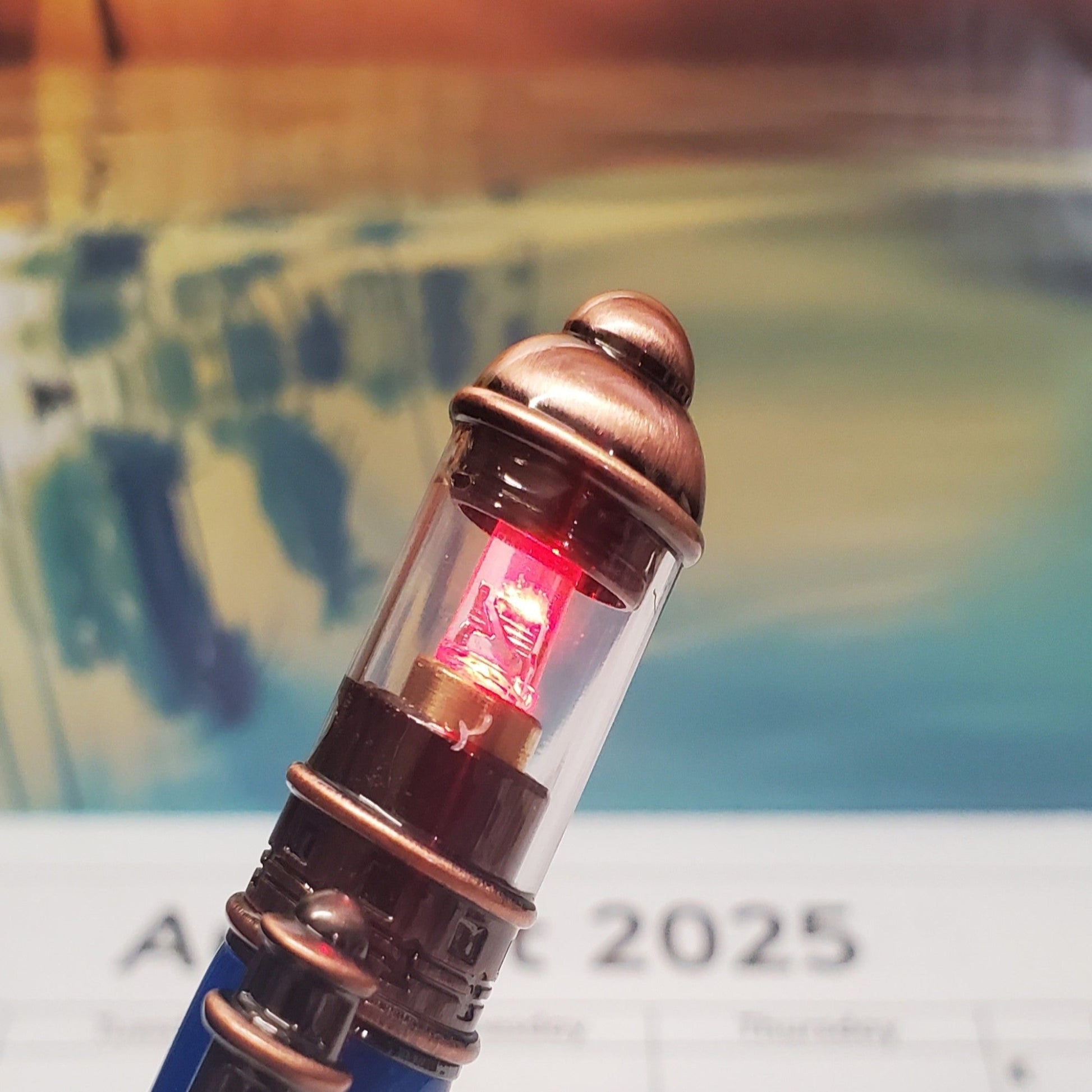 Cloe-up of the pen cap featuring a lighthouse light that emits flashes of light.