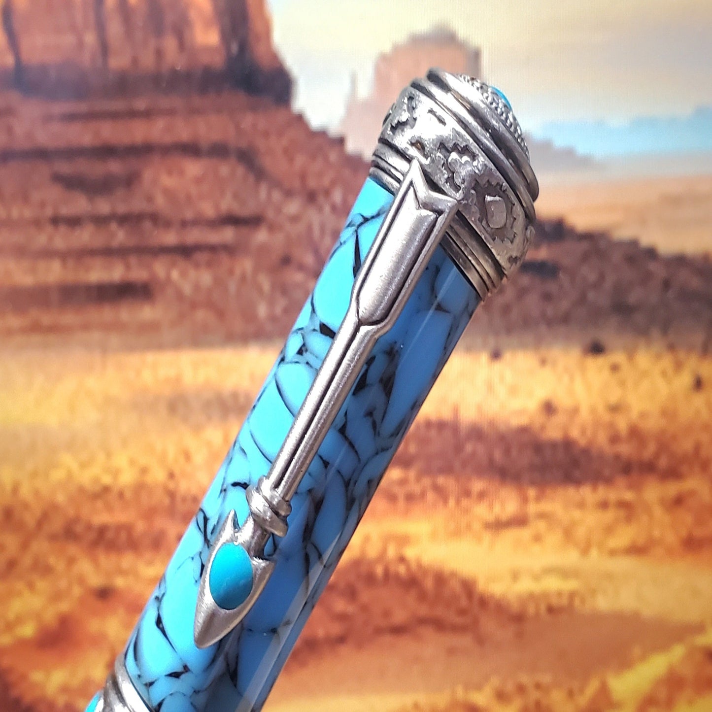 Top of Southwestern Pen featuring sliver clip with turquoise accents and Native American patterns