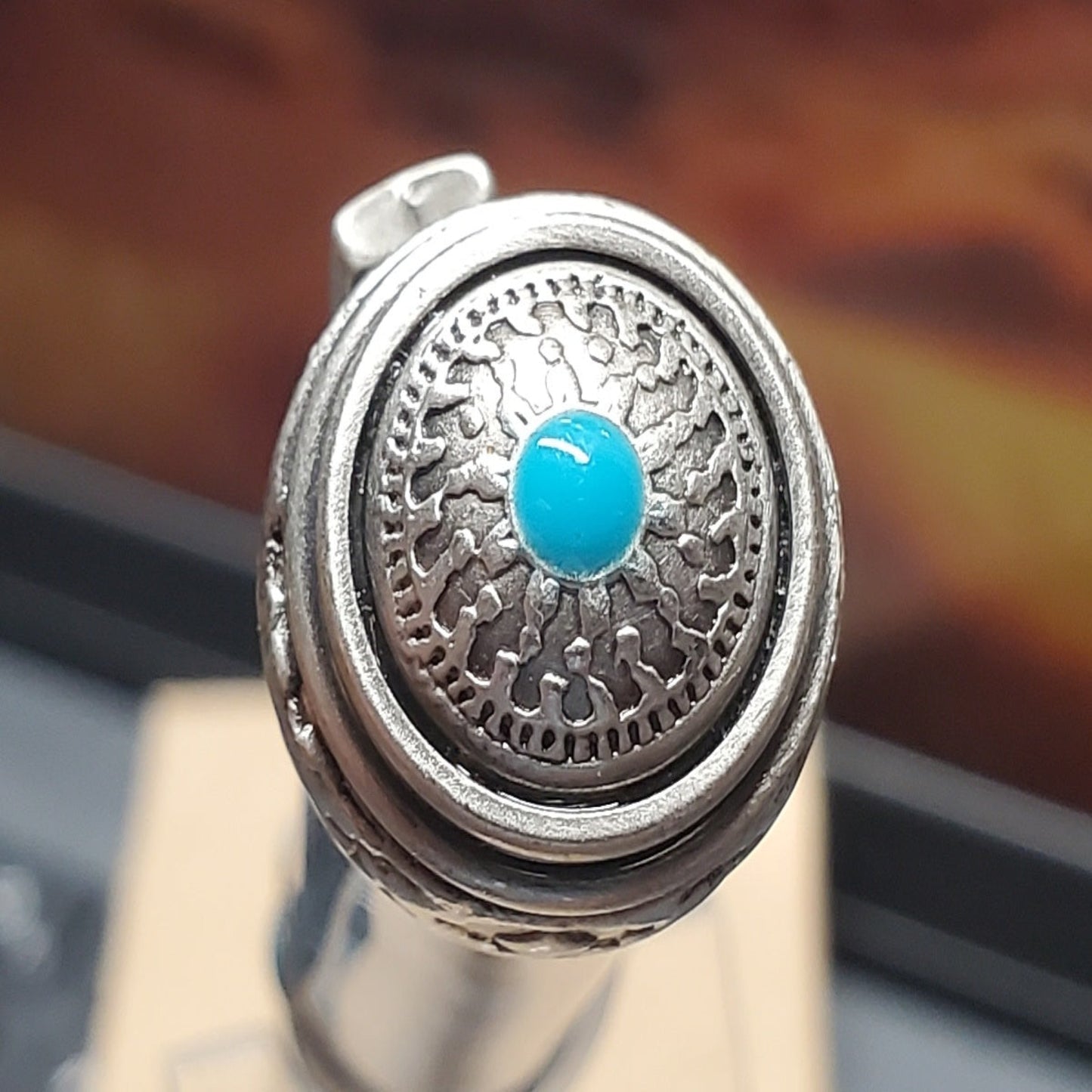 Top of southwestern Writing pen featuring Native American Designs and a turquoise center.
