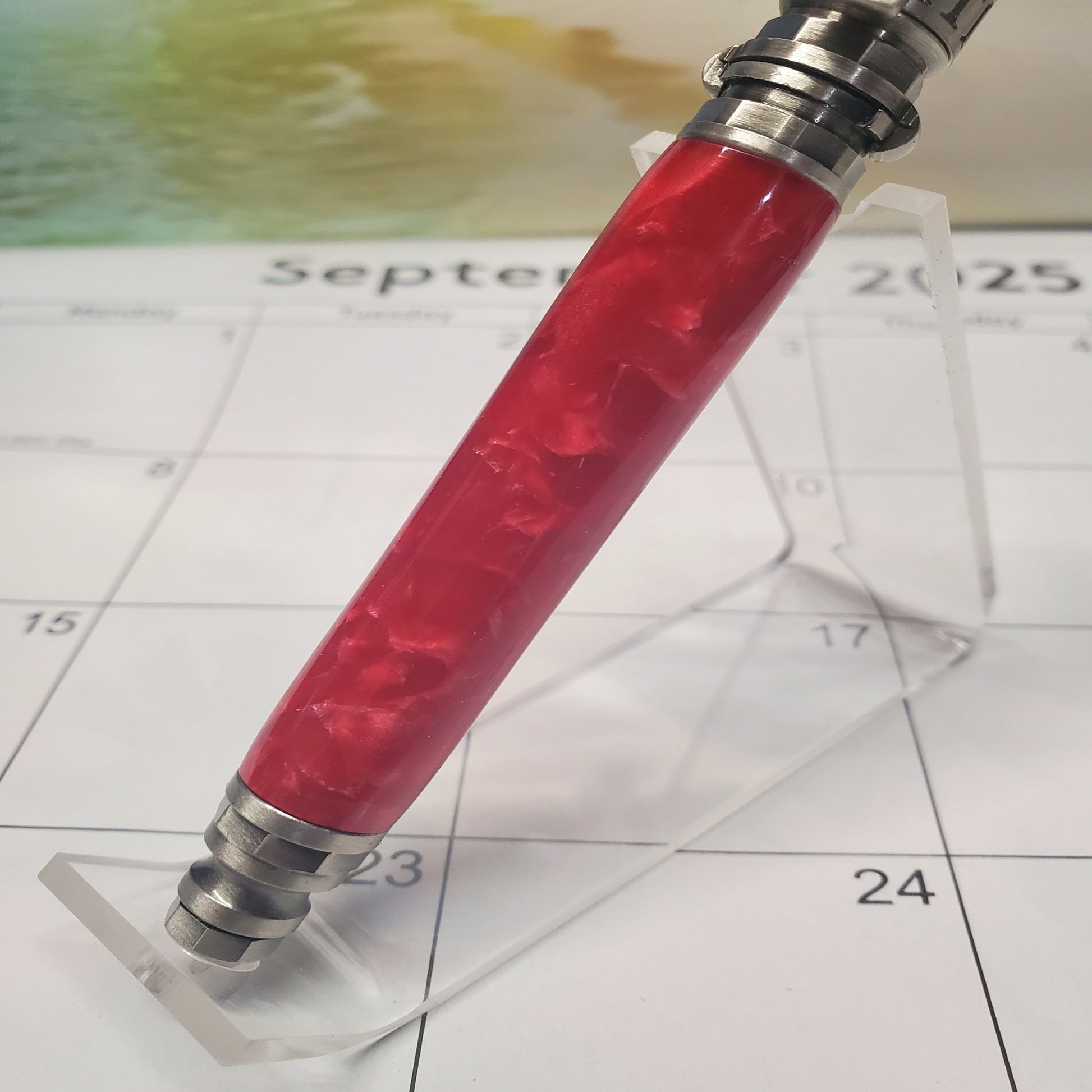 lower half of red firefighter pen with silver accents. 